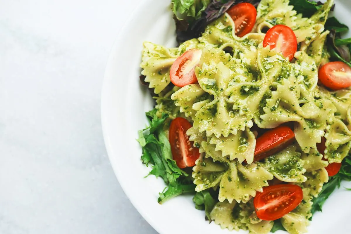 Fresh pasta topped with basil and vegetables