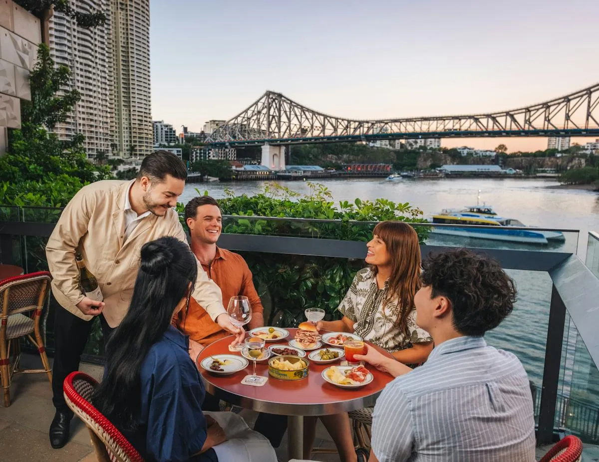 Outdoor dining scene with friends near the waterfront